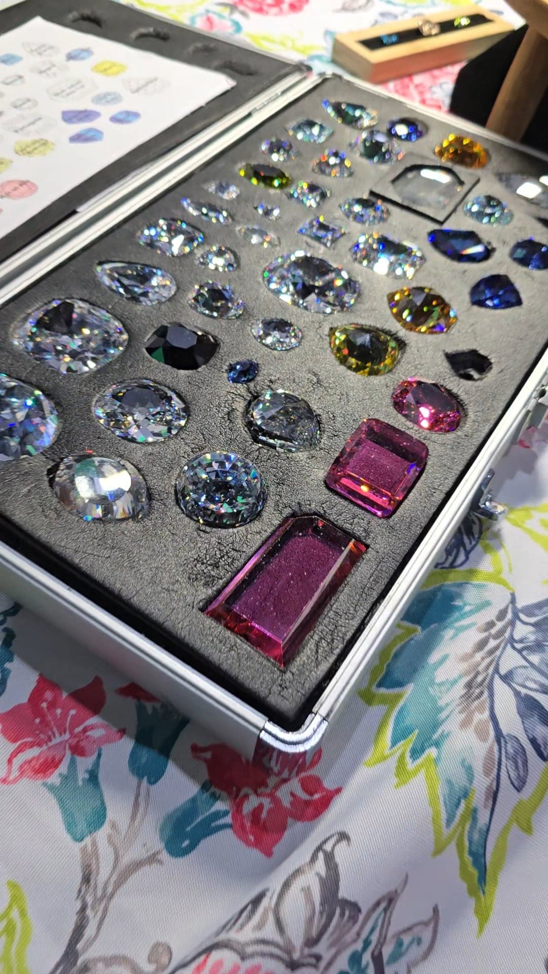 A closer, angled view of the replica case, its stones catching rainbow light