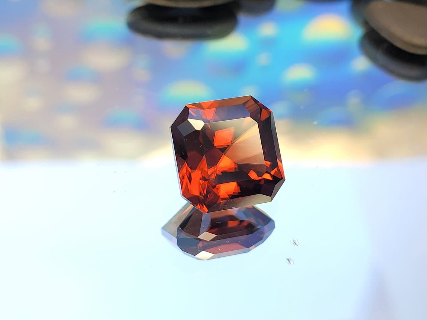 A square orange-red gemstone glowing like an ember